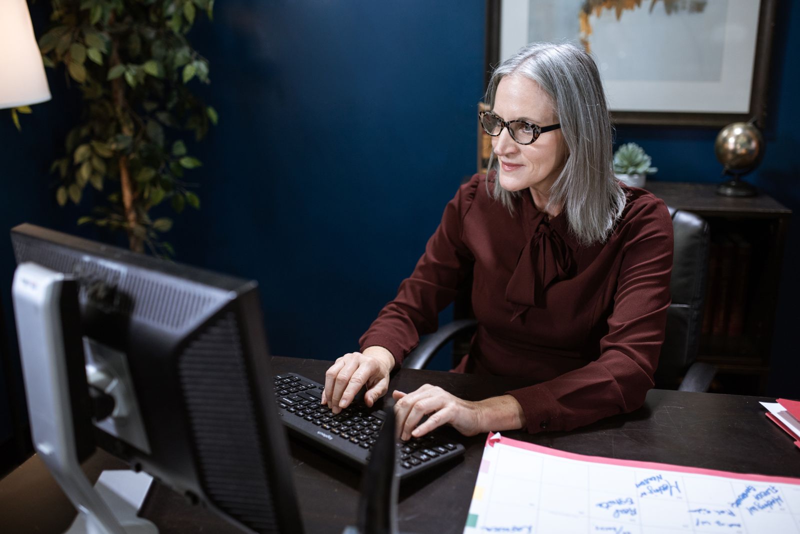 Senior woman using a computer at her desk